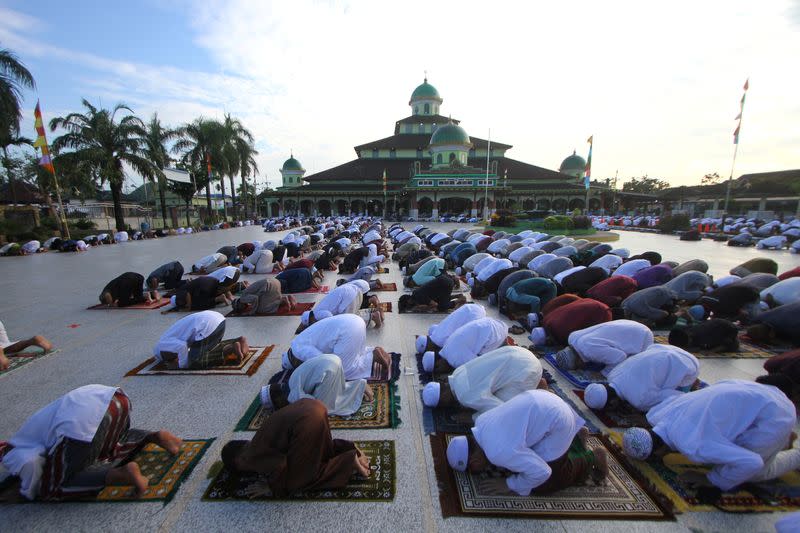 Indonesian Muslim men take part in prayers during Eid al-Fitr, the Muslim festival marking the end the holy fasting month of Ramadan, at a mosque, in Banjarmasin, South Kalimantan Province, Indonesia, amid the spread of coronavirus disease