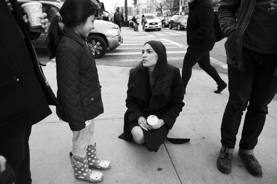 Ocasio-Cortez talks with a staff member's daughter near the office in Jackson Heights.