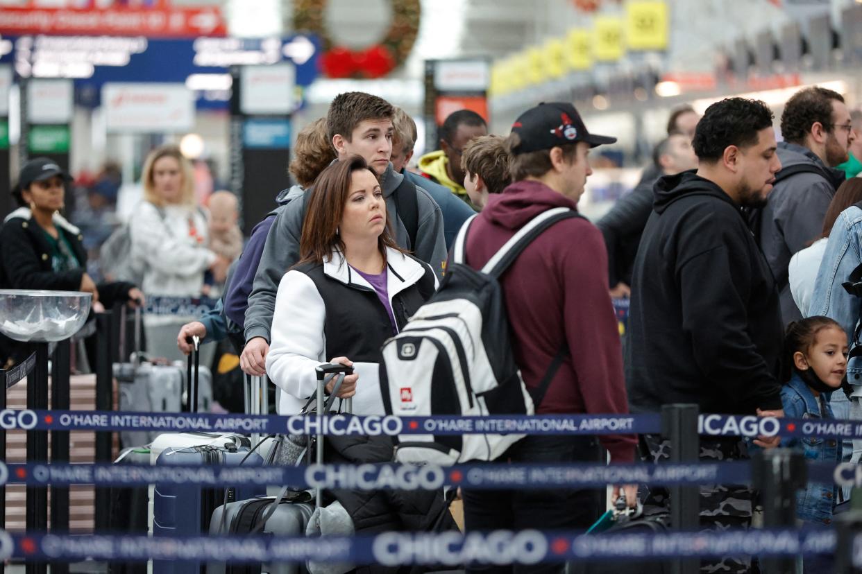 Travelers check-in for their flights at Chicago O'Hare International Airport in Chicago on Dec. 22, 2023.