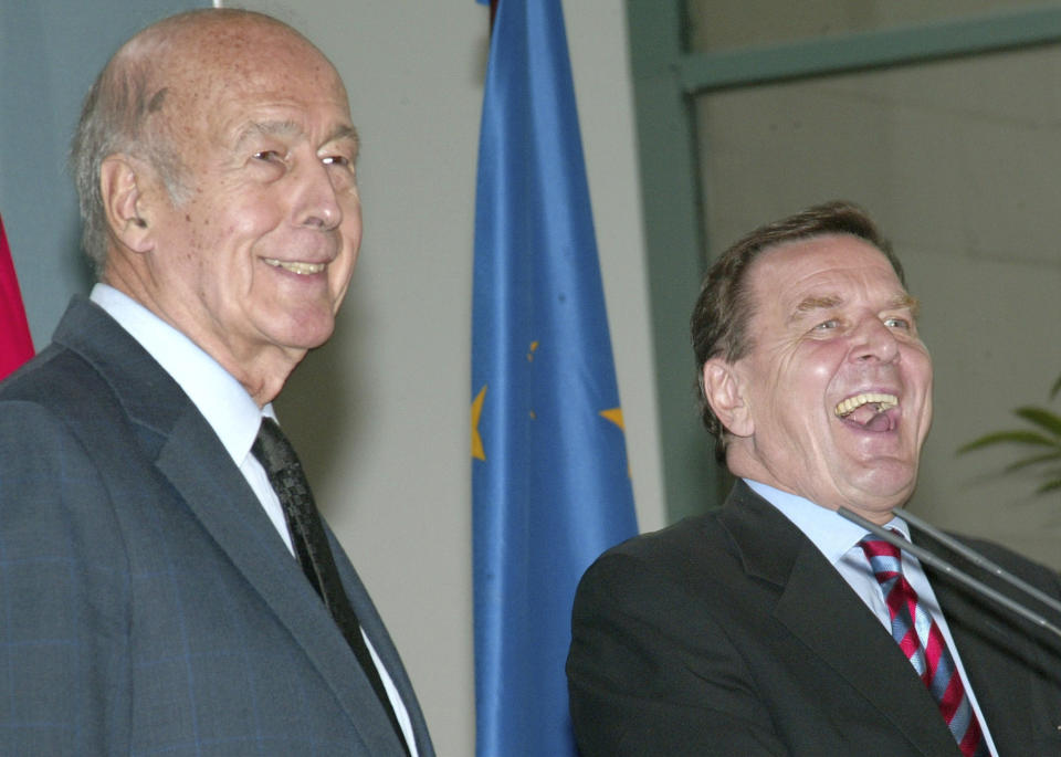FILE - In this Sept.9, 2003 file photo, German Chancellor Gerhard Schroeder, right, and then French President of the European Convention, Valery Giscard d' Estaing share a laugh in the Berlin Chancellery. Valery Giscard d’Estaing, the president of France from 1974 to 1981 who became a champion of European integration, has died Wednesday, Dec. 2, 2020 at the age of 94, his office and the French presidency said. (AP Photo/Fritz Reiss, File)