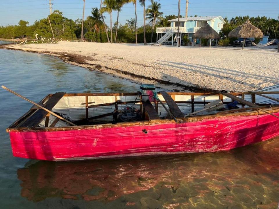 A red homemade migrant boat sits on the shore of Long Key in the Florida Keys Tuesday, March 7, 2023. The U.S. Border Patrol says 17 men from Cuba arrived on the vessel.