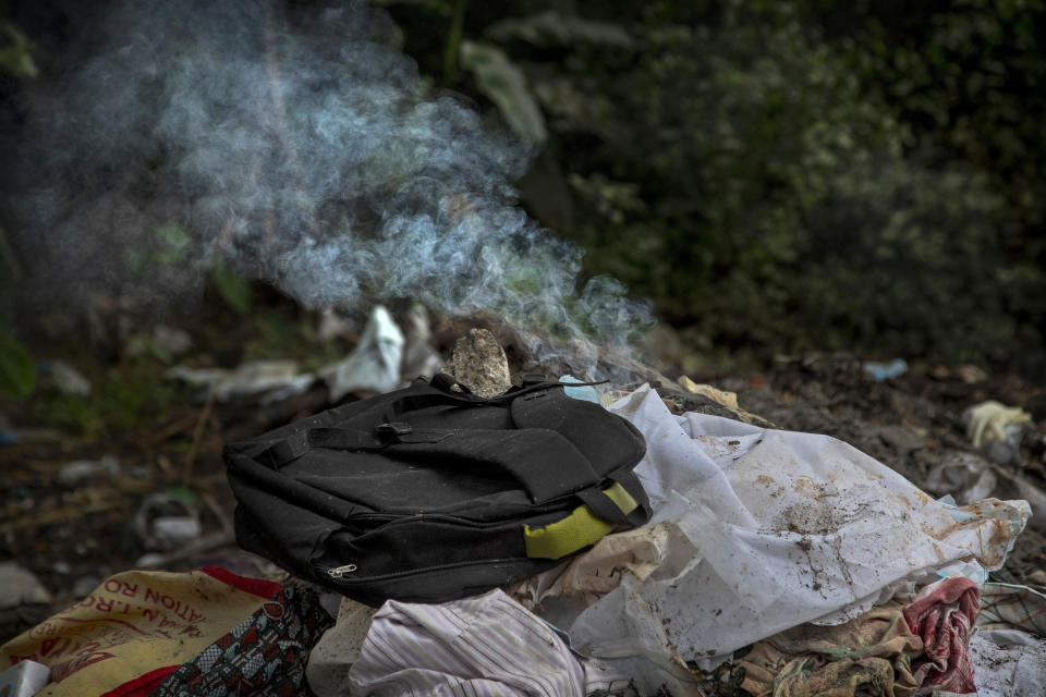 Clothes of a deceased COVID-19 victim lie in a cremation ground in Gauhati, India, Friday, July 2, 2021. The personal belongings of cremated COVID-19 victims lie strewn around the grounds of the Ulubari cremation ground in Gauhati, the biggest city in India’s remote northeast. It's a fundamental change from the rites and traditions that surround death in the Hindu religion. And, perhaps, also reflects the grim fears grieving people shaken by the deaths of their loved ones — have of the virus in India, where more than 405,000 people have died. (AP Photo/Anupam Nath)