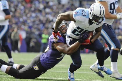 Tennessee Titans running back Shonn Greene (23) is tackled by Baltimore Ravens outside linebacker Albert McClellan (50) during the first half of an NFL football game in Baltimore, Sunday, Nov. 9, 2014. (AP Photo/Gail Burton)