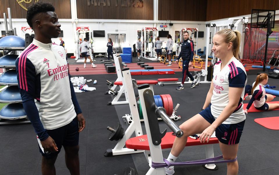Bukayo Saka chats to Beth Mead of Arsenal during the Arsenal training session at London Colney on February 10, 2023 in St Albans, England - Getty Images/David Price