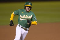 Oakland Athletics' Jed Lowrie rounds third base to score on a single by Matt Chapman during the seventh inning against the Los Angeles Angels in a baseball game Friday, May 28, 2021, in Oakland, Calif. (AP Photo/Tony Avelar)
