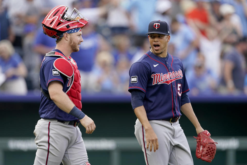 Minnesota Twins relief pitcher Hansel Robles, right, and catcher Ryan Jeffers celebrate after their baseball game against the Kansas City Royals Saturday, June 5, 2021, in Kansas City, Mo. The Twins won 5-4. (AP Photo/Charlie Riedel)