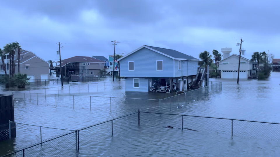 Houses stand in flood waters in the aftermath of Hurricane Nicholas in Jamaica Beach, Texas, September 14, 2021, in this screen grab obtained from a social media video. / Credit: @HEATHERGTX via REUTERS