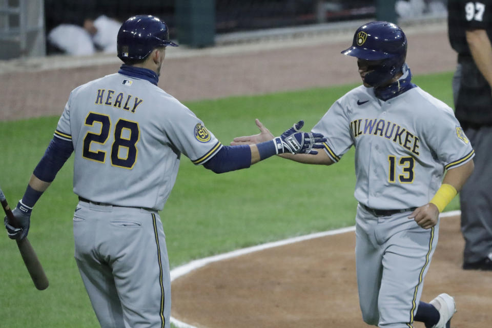 Milwaukee Brewers' Mark Mathias, right, celebrates with Ryon Healy after scoring on a one-run single by Eric Sogard during the third inning of a baseball game against the Chicago White Sox in Chicago, Wednesday, Aug. 5, 2020. (AP Photo/Nam Y. Huh)