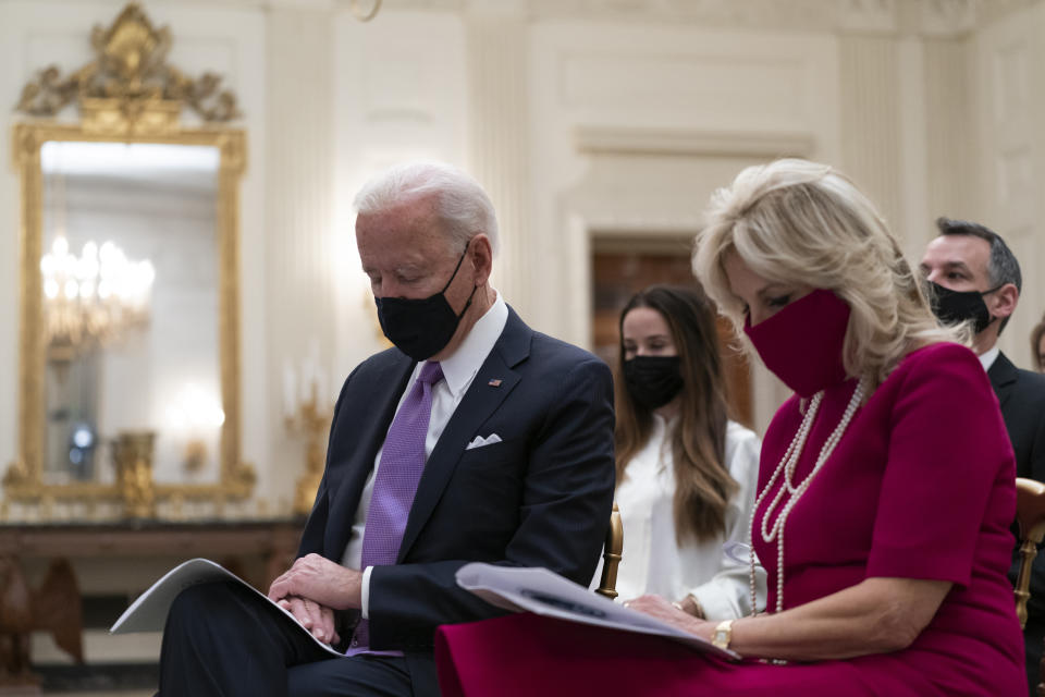 President Joe Biden bows his head in prayer, during a virtual Presidential Inaugural Prayer Service, accompanied by first lady Jill Biden, second from right, in the State Dinning Room of the White House, Thursday, Jan. 21, 2021, in Washington. (AP Photo/Alex Brandon)