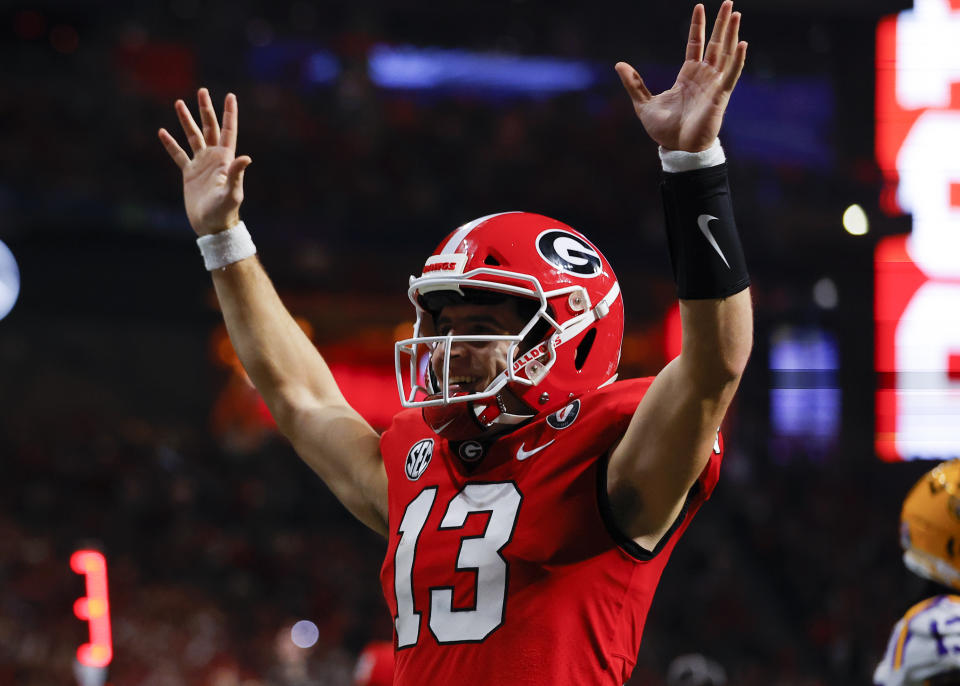 ATLANTA, GA - DECEMBER 03: Stetson Bennett #13 of the Georgia Bulldogs reacts after a touchdown against the LSU Tigers during the second half of the SEC Championship game at Mercedes-Benz Stadium on December 3, 2022 in Atlanta, Georgia. (Photo by Todd Kirkland/Getty Images)