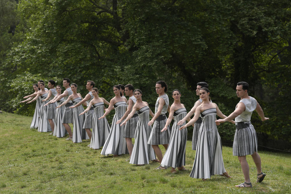 Performers take part in the official ceremony of the flame lighting for the Paris Olympics, at the Ancient Olympia site, Greece, Tuesday, April 16, 2024. The flame will be carried through Greece for 11 days before being handed over to Paris organizers on April 26. (AP Photo/Thanassis Stavrakis)