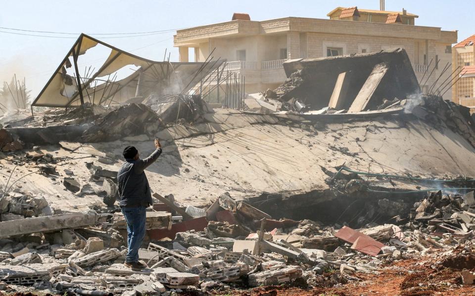 A man stands by the rubble of a destroyed building in the aftermath of an Israeli airstrike on the village of Sarein, near Baalbek in east central Lebanon on March 12, 2024.