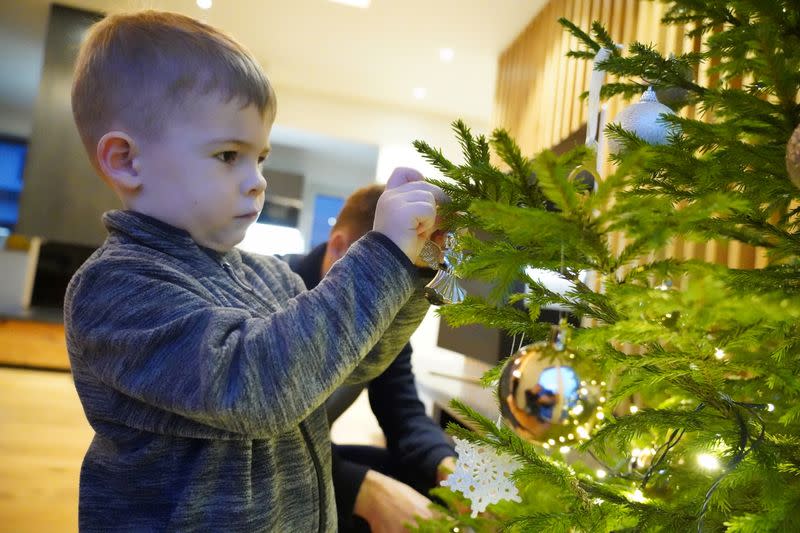 Richard Sepp decorates Christmas tree found with help of a mobile application in Kuuresaare