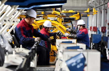 Employees work on a drilling machine production line at a factory in Zhangjiakou, Hebei province, China November 14, 2018. REUTERS/Stringer/Files