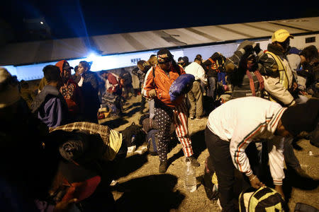 Central American migrants, moving in a caravan through Mexico, wait next to a railway line before embarking on a new leg of their travels, in Tlaquepaque, in Jalisco state, Mexico April 18, 2018. Picture taken April 18, 2018. REUTERS/Edgard Garrido