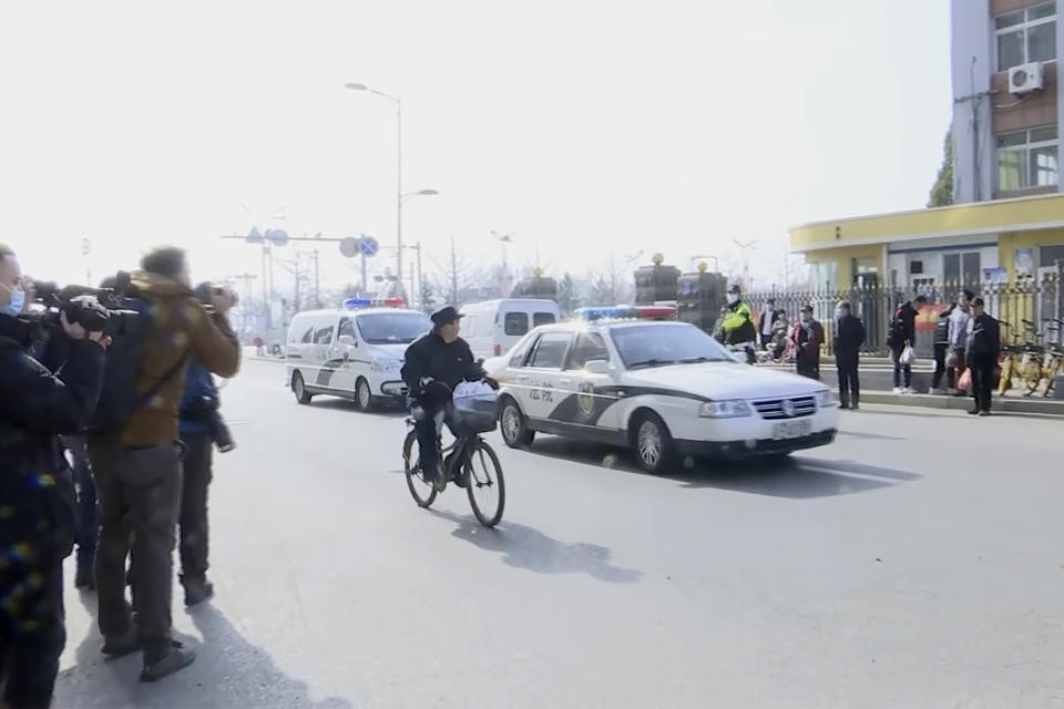 In this image taken from video, a police van arrives at a court building in Dandong in northeastern China's Liaoning Province, Friday, March 19, 2021. China was expected to open the first trial Friday for Michael Spavor, one of two Canadians who have been held for more than two years in apparent retaliation for Canada's arrest of a senior Chinese telecom executive. (AP Photo)