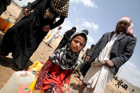 A girl waits to collect water from a public tap amidst an acute water shortage in Sanaa May 13, 2015. REUTERS/Mohamed al-Sayaghi