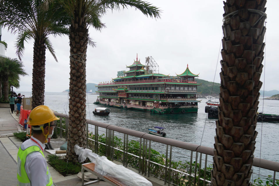 Hong Kong's iconic Jumbo Floating Restaurant is towed away in Hong Kong, Tuesday, June 14, 2022. Hong Kong's iconic restaurant on Tuesday departed the city, after its parent company failed to find a new owner and lacked funds to maintain the establishment amid months of COVID-19 restrictions. (AP Photo/Kin Cheung)