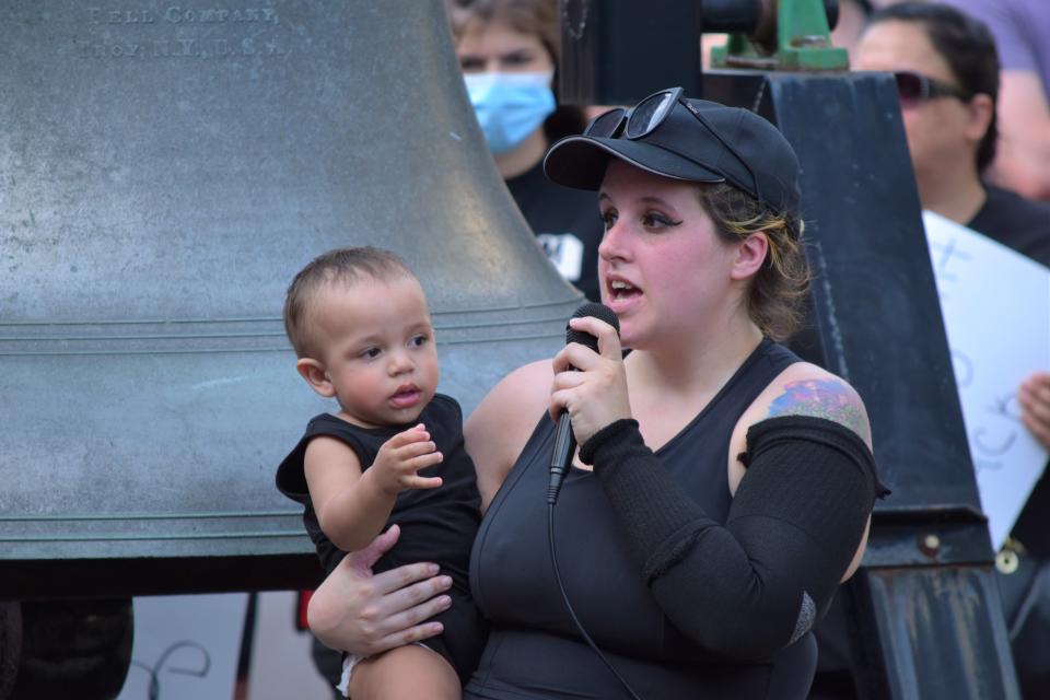 Freedom March organizer Brittany Haynman, holding her son, speaks to the crowd on July 4 in downtown Canton. The group rallied for civil rights.