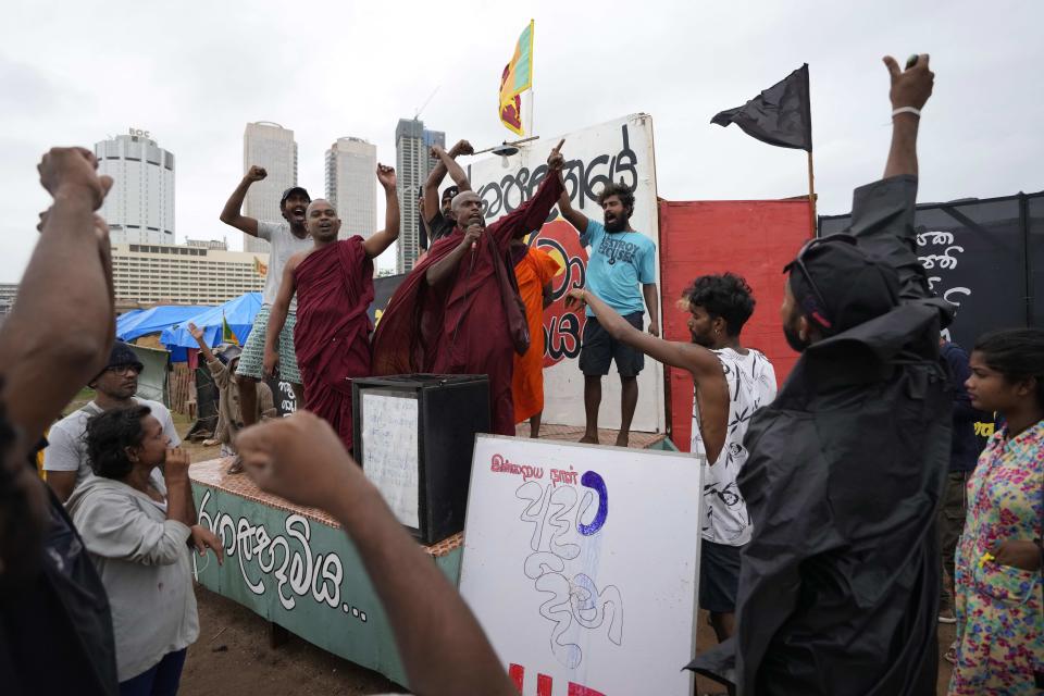 Protesters shout against president Ranil Wickremesinghe's government in Colombo, Sri Lanka, Wednesday, Aug. 3, 2022. Sri Lanka's new president says his government is preparing a national policy roadmap for the next 25 years that aims to cut public debt and turn the country into a competitive export economy as it seeks a way out of its worst economic disaster. (AP Photo/Eranga Jayawardena)