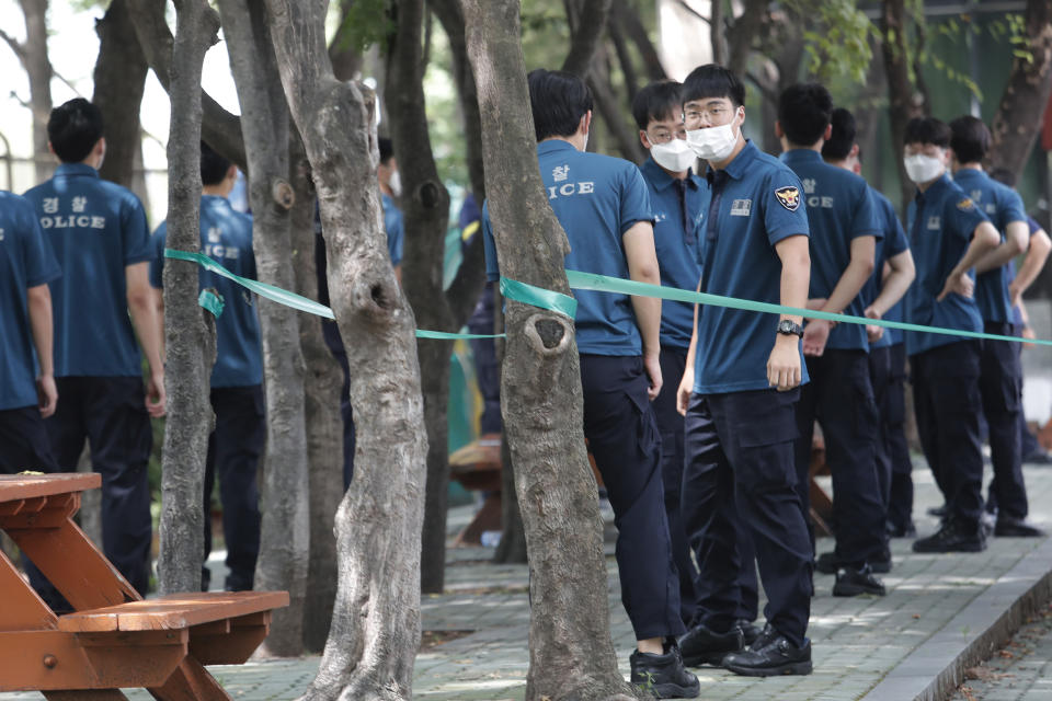 Police officers wait for their COVID-19 testing at a makeshift clinic at the Seoul Metropolitan Police Agency in Seoul, South Korea, Wednesday, Aug. 19, 2020. (AP Photo/Ahn Young-joon)