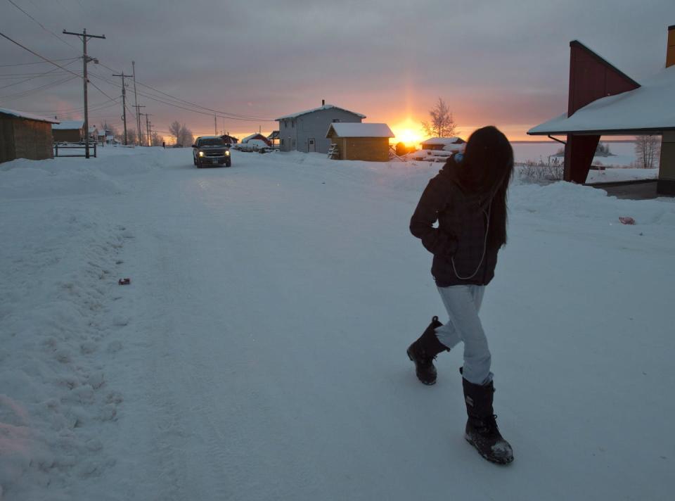 <span class="caption">A girl walks along the streets as the sun rises in December 2012, on the Fort Hope First Nation in northern Ontario, in an area with rich mineral and metal deposits.</span> <span class="attribution"><span class="source">THE CANADIAN PRESS/Ryan Remiorz</span></span>