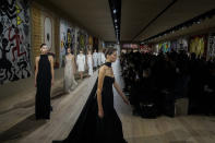 Models wear creations for the Dior Spring-Summer 2022 Haute Couture fashion collection collection, in Paris, Monday, Jan. 24, 2022. (AP Photo/Michel Euler)