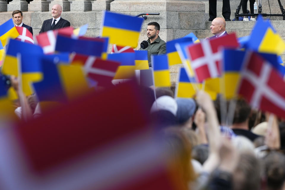 Ukrainian President Volodymyr Zelenskyy addresses the Danish people from the steps of Christiansborg palace, the seat of Danish Parliament, in Copenhagen, Denmark, Monday, Aug. 21, 2023. Thousands of people had gathered in the palace courtyard to hear his speech, many waving Ukrainian or Danish flags. (Claus Bech/Ritzau Scanpix via AP)