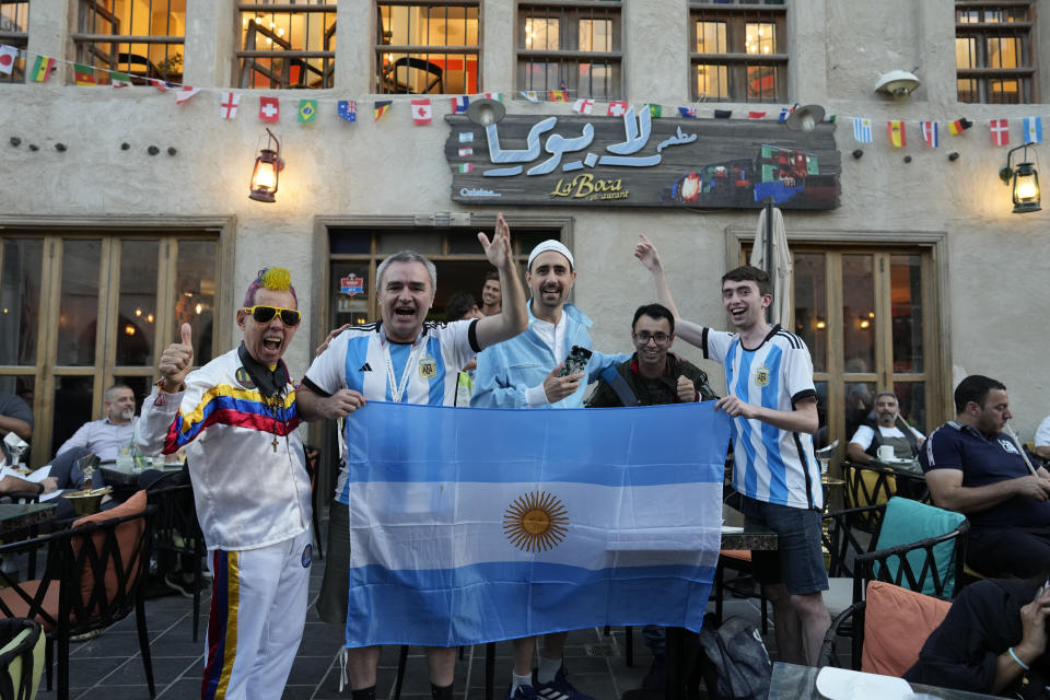 Fans of Argentina cheer for their team in Souq Waqif market in Doha, Qatar, Thursday, Dec. 15, 2022. Argentina will face France in the World Cup final match on Dec. 18. (AP Photo/Andre Penner)