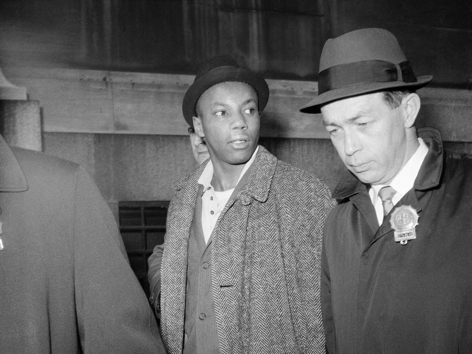 Norman 3X Butler, 26, suspect in the slaying of black nationalist leader Malcolm X, is escorted by detectives at police headquarters at 240 Centre Street after his arrest, in New York, Feb. 26, 1965.