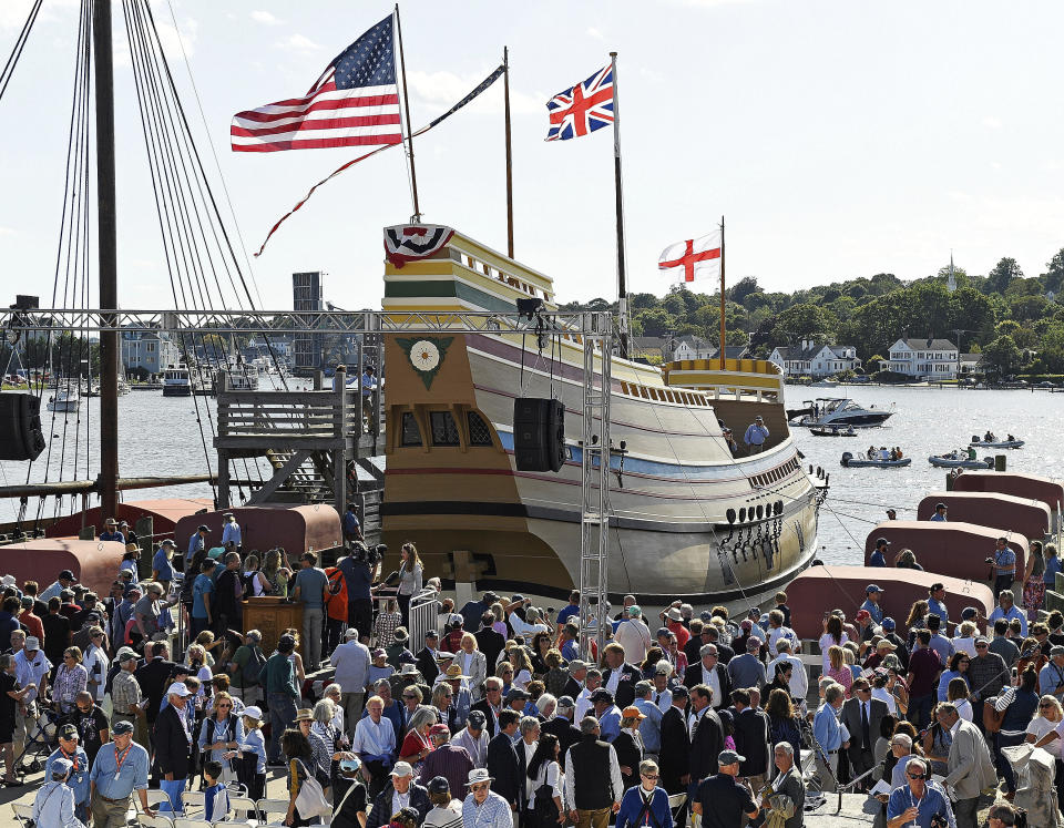 FILE- In this Sept. 7, 2019 file photo, guests come forward to see the Mayflower II afloat after a re-launch ceremony at the Mystic Seaport in Mystic Conn. After undergoing more than three years of major renovations in Connecticut and months of delays due to the COVID-19 pandemic, the replica of the Mayflower is ready to return home. (Sean D. Elliot/The Day via AP)