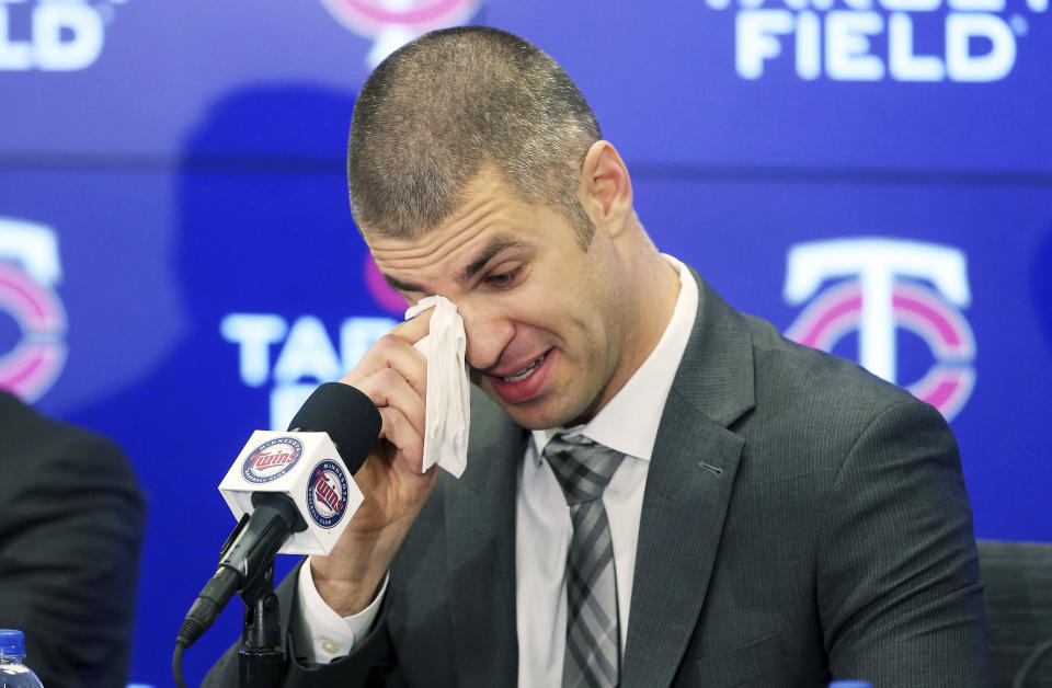 Joe Mauer wipes away tears during his retirement news conference Monday, Nov. 12, 2018, in Minneapolis, after playing 15 major league seasons, all with the Minnesota Twins baseball team. (AP Photo/Jim Mone)