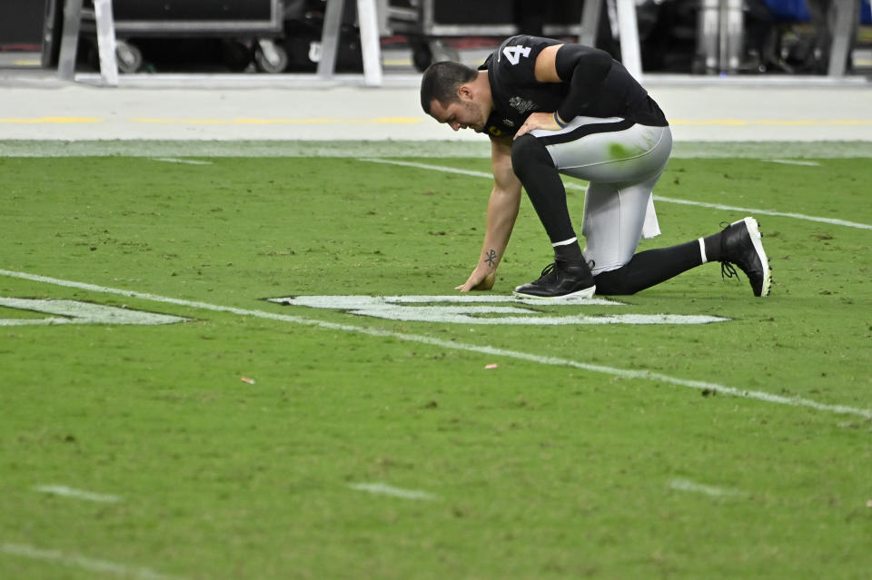 Las Vegas Raiders quarterback Derek Carr (4) kneels on the field after losing to the Buffalo Bills in an NFL football game, Sunday, Oct. 4, 2020, in Las Vegas. (AP Photo/David Becker)