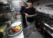 Customers enjoy dinner sitting inside a motorhome camper parked at the Belgian restaurant Matthias And Sea in Tarcienne