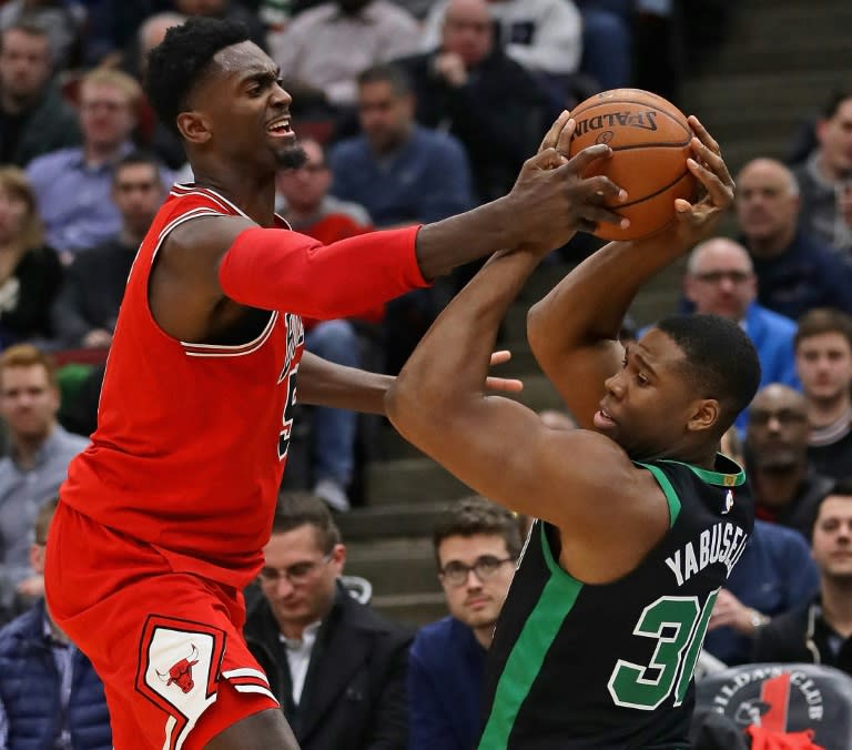 Bobby Portis (L) of the Chicago Bulls and Guerschon Yabusele of the Boston Celtics battle for the ball at the United Center