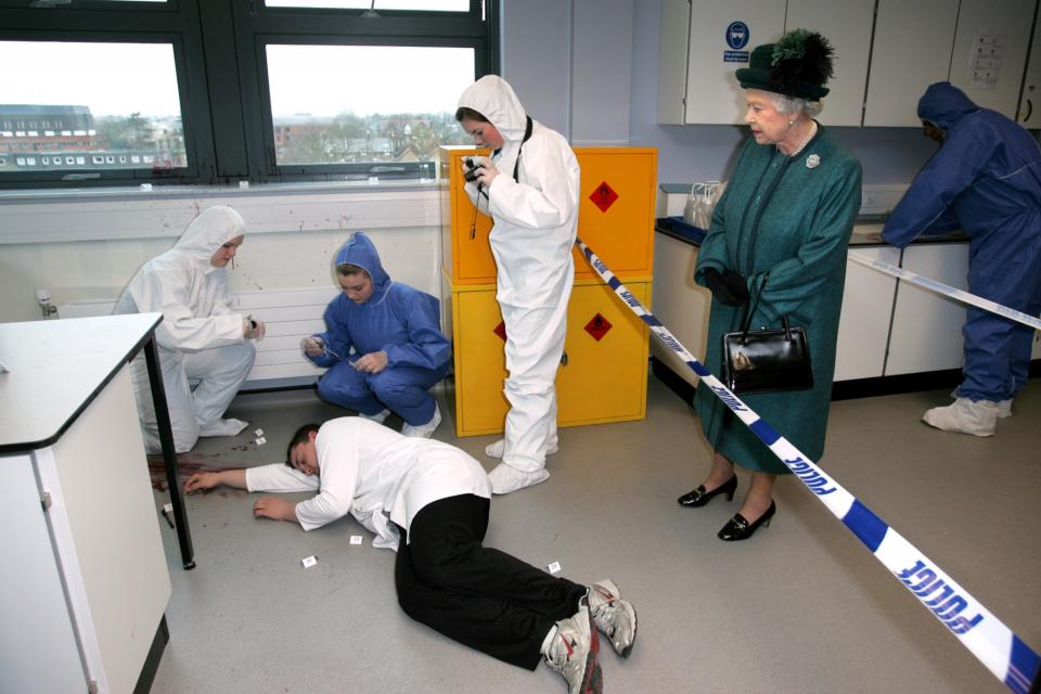 <p>Forensic science students demonstrate a simulated crime scene during a visit from The Queen. (PA) </p>