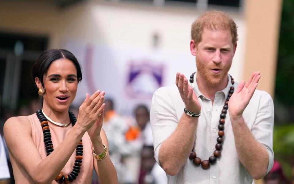 Britain's Prince Harry (R), Duke of Sussex, and Britain's Meghan (L), Duchess of Sussex, take part in activities as they arrive at the Lightway Academy in Abuja on May 10, 2024 as they visit Nigeria as part of celebrations of Invictus Games anniversary.