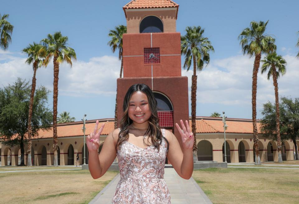 Shelomith Hoy makes the sign for 2023, the year she will graduate from Palm Springs High School.  Hoy will graduate in just three years and has also earned two associates degrees fom College of the Desert.  She is photographed at Palm Springs High School on May 17, 2023.