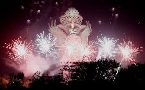 Fireworks explode after midnight over Garuda Wisnu Kencana cultural park part of New Year celebrations in Bali, Indonesia  - Credit: Rex