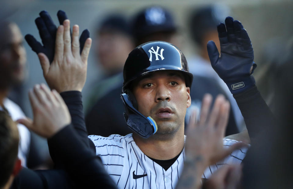 New York Yankees' Marwin Gonzalez is congratulated after his home run against the Oakland Athletics during the second inning of a baseball game Tuesday, June 28, 2022, in New York. (AP Photo/Noah K. Murray)