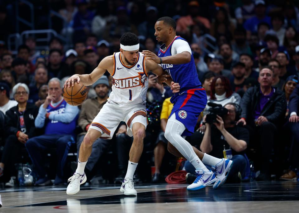 Devin Booker #1 of the Phoenix Suns controls the ball against Norman Powell #24 of the LA Clippers in the first half at Crypto.com Arena on Jan. 8, 2024, in Los Angeles, California.