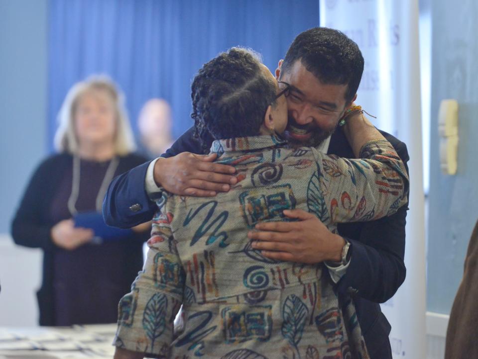 Barnstable County Human Rights Advisory Commission member George “Leo” Blandford gives award recipient Ngina Lythcott a hug after she accepted the Tim McCarthy Award on Monday in Hyannis. The award was presented to Lythcott by Brian O’Malley, the Provincetown representative to the county assembly of delegates. This award is given to an individual or organization that promotes human rights. Lythcott has been an active voice for children and racial justice in Provincetown for the past 20 years.