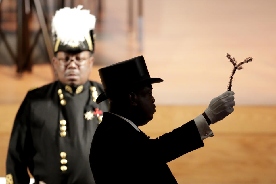 A member of the Most Worshipful Prince Hall Grand Lodge of Maryland holds up a branch during a ceremony for the late U.S. Rep. Elijah Cummings during a viewing service at Morgan State University, Wednesday, Oct. 23, 2019, in Baltimore. The Maryland congressman and civil rights champion died Thursday, Oct. 17, at age 68 of complications from long-standing health issues. (AP Photo/Julio Cortez)