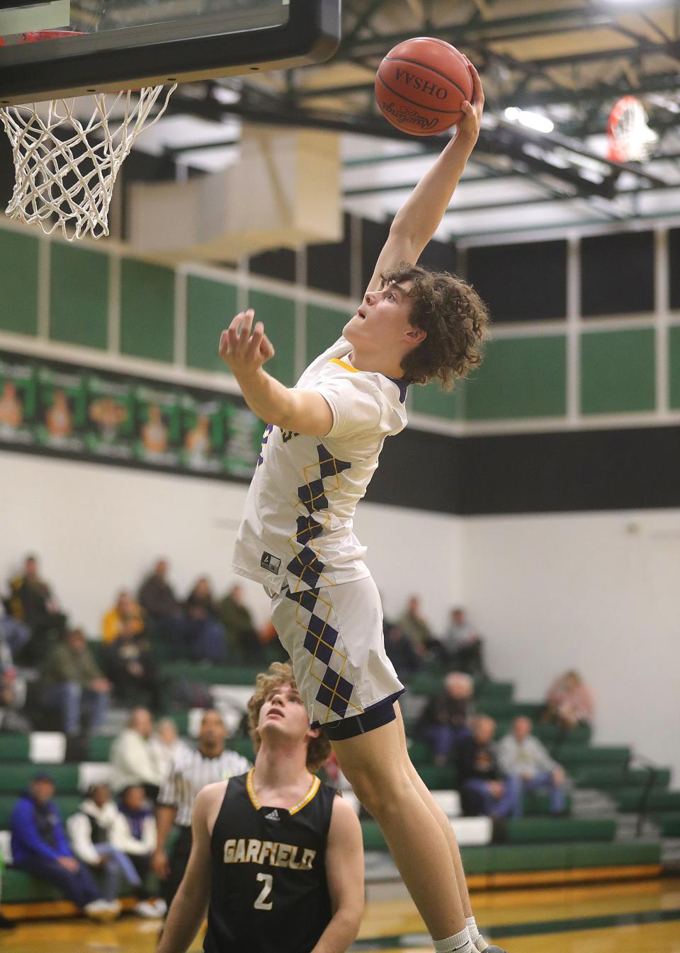 Kaden Davis of Tallmadge goes up for a dunk during the Greater Akron Basketball Coaches Association game on Tuesday, March 14, 2023 in Granger Township, Ohio, at Highland High School.
