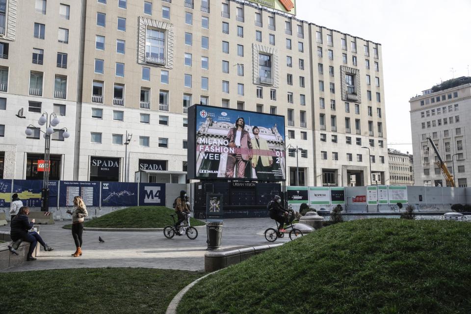 A giant screen streams a Prada fashion live show during the Milan's fashion week in Milan, Italy, Sunday, Jan. 17, 2021. (AP Photo/Luca Bruno)