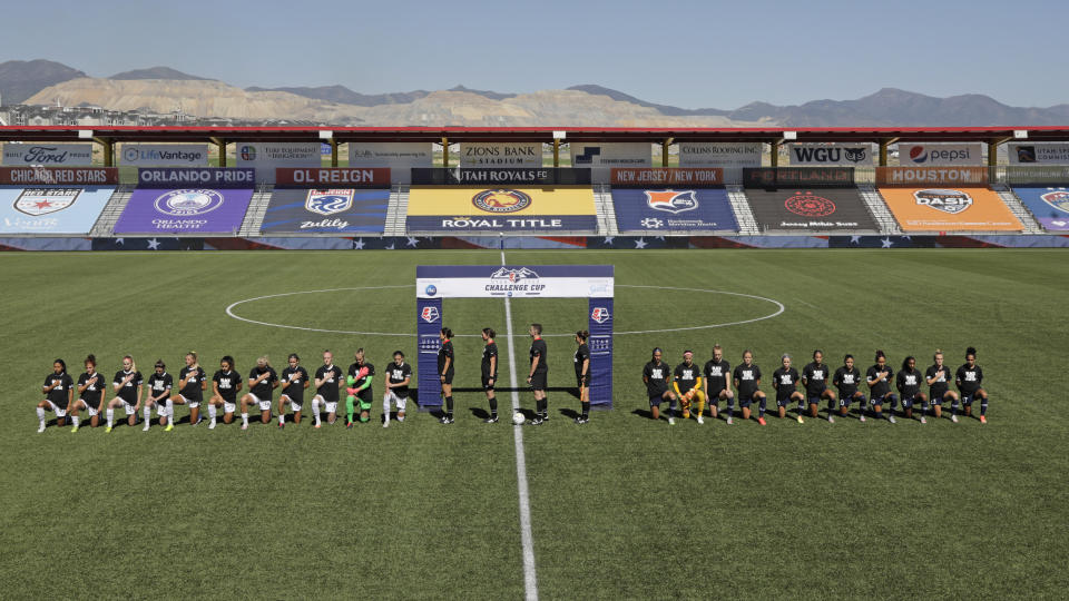 Players for the Portland Thorns, left, and the North Carolina Courage kneel during the national anthem before the start of their NWSL Challenge Cup soccer match at Zions Bank Stadium Saturday, June 27, 2020, in Herriman, Utah. (AP Photo/Rick Bowmer)