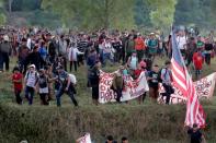 Migrants, mainly from Central America and marching in a caravan, walk after crossing the Suchiate river, on the outskirts of Ciudad Hidalgo