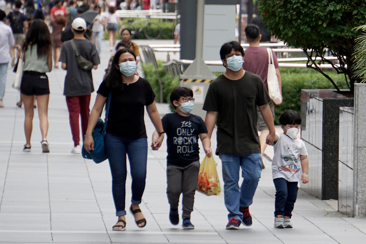 A family wearing face masks seen in Orchard Road on 21 March 2020. (PHOTO: Dhany Osman / Yahoo News Singapore) 