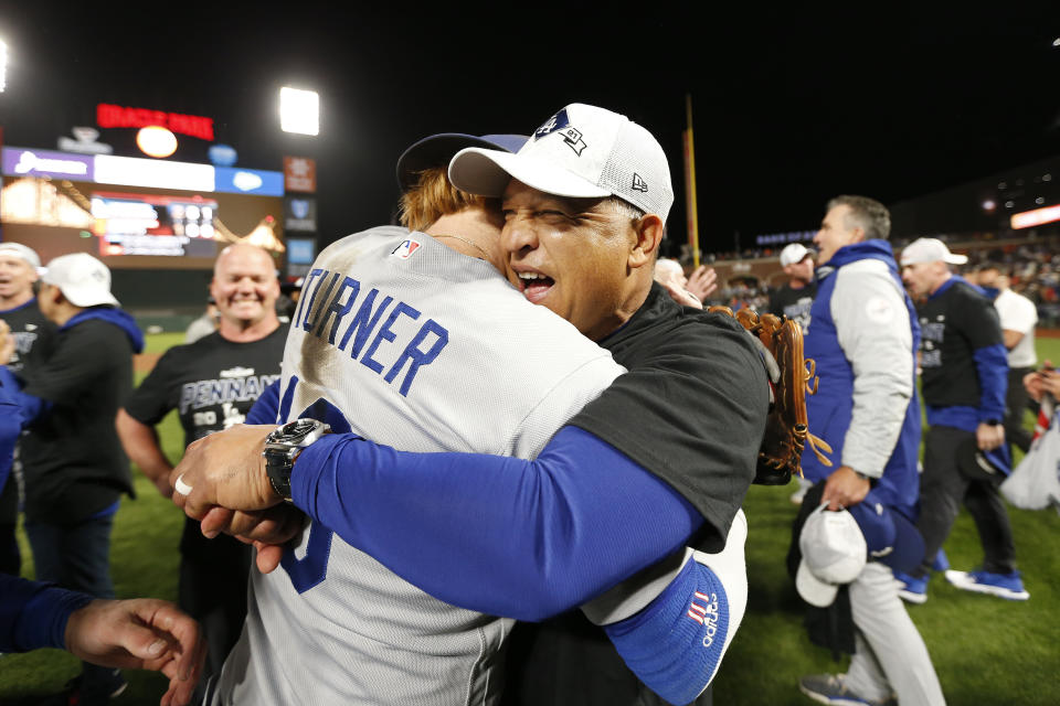 Los Angeles Dodgers' Justin Turner, left, celebrates with manager Dave Roberts after defeating the San Francisco Giants in Game 5 of a baseball National League Division Series Thursday, Oct. 14, 2021, in San Francisco. (AP Photo/Jed Jacobsohn)