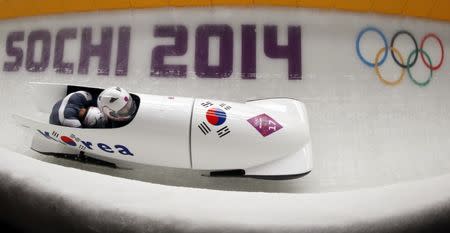 South Korea's pilot Won Yun-jong (front) and Seo Young-woo speed down the track in the men's two-man bobsleigh competition at the 2014 Sochi Winter Olympics February 16, 2014. REUTERS/Fabrizio Bensch